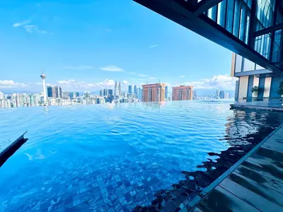 a swimming pool with a city skyline in the background at Lucentia Residence At Bukit Bintang KLCC Pavilion in Kuala Lumpur
