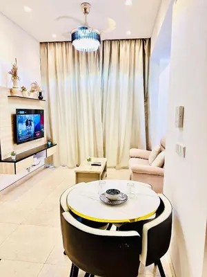 a living room with a table and a tv at Lucentia Residence At Bukit Bintang KLCC Pavilion in Kuala Lumpur