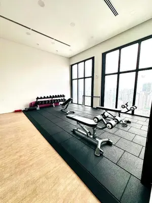 a fitness room with a gym with benches and tables at Lucentia Residence At Bukit Bintang KLCC Pavilion in Kuala Lumpur