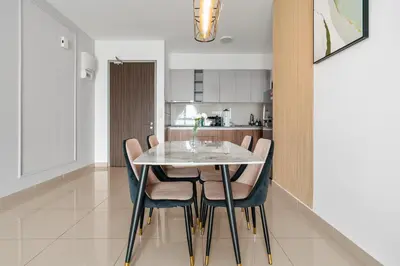 a dining room with a white table and chairs at M Vertica KLCC View IKEA Velocity in Kuala Lumpur