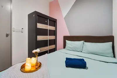 a bedroom with a bed with a vase of flowers and candles at M Vertica KLCC View IKEA Velocity in Kuala Lumpur