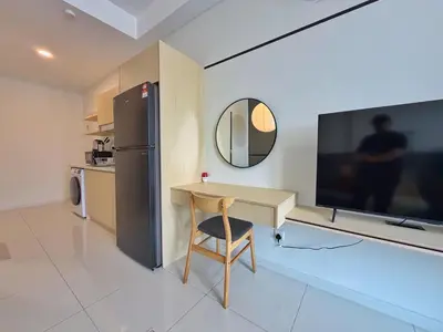 a kitchen with a desk and a refrigerator and a mirror at KLCC View Majestic Cozy Studio with Rooftop Pool in Kuala Lumpur