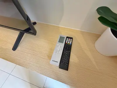 a remote control sitting on top of a table at KLCC View Majestic Cozy Studio with Rooftop Pool in Kuala Lumpur