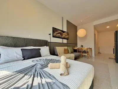 a bedroom with a bed with a stuffed animal on it at KLCC View Majestic Cozy Studio with Rooftop Pool in Kuala Lumpur