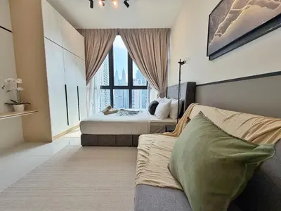 a bedroom with two beds and a large window at KLCC View Majestic Cozy Studio with Rooftop Pool in Kuala Lumpur