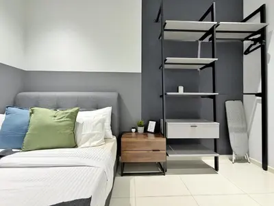 a bedroom with a bed and a shelving unit at Majestic Luxe 1BR Apt with KLCC View Rooftop Pool in Kuala Lumpur