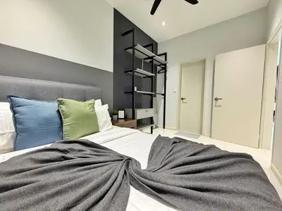 a bedroom with a large bed with a blanket on it at Majestic Luxe 1BR Apt with KLCC View Rooftop Pool in Kuala Lumpur