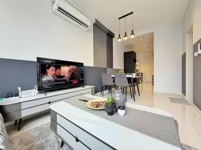 a living room with a large flat screen tv at Majestic Luxe 1BR Apt with KLCC View Rooftop Pool in Kuala Lumpur
