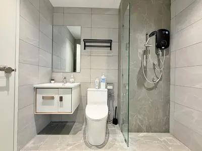 a bathroom with a shower and a toilet and a sink at Majestic Luxe 1BR Apt with KLCC View Rooftop Pool in Kuala Lumpur