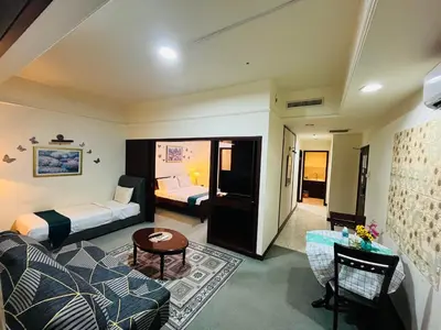 a hotel room with a bed and a living room at Arba Suite Times Square KL in Kuala Lumpur