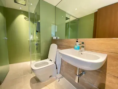a bathroom with a sink and a toilet at Garden City of Lights Vortex Suites in Kuala Lumpur