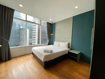 a bedroom with a bed and a large window at Garden City of Lights Vortex Suites in Kuala Lumpur