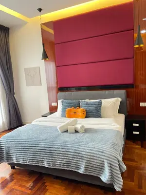 a bedroom with a large bed with two pumpkins on it at The Mews Klcc by Annie in Kuala Lumpur