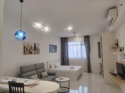 a living room with a couch and a table at CHAMBERS RESIDENCE KLCC By DELUXE HOME in Kuala Lumpur