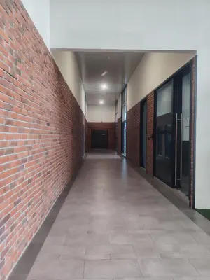 an empty hallway with a brick wall and a sidewalk at CHAMBERS RESIDENCE KLCC By DELUXE HOME in Kuala Lumpur