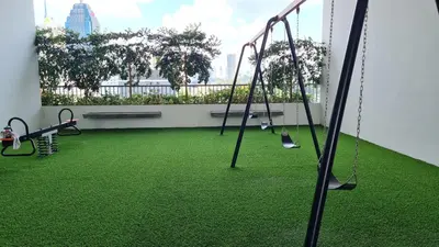 an empty playground with swings and green grass at CHAMBERS RESIDENCE KLCC By DELUXE HOME in Kuala Lumpur