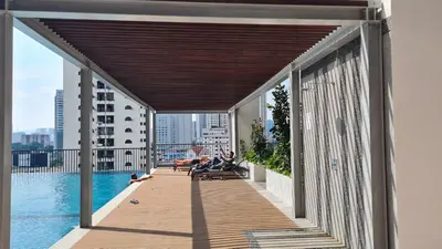 a view from the balcony of a building with a pool at CHAMBERS RESIDENCE KLCC By DELUXE HOME in Kuala Lumpur