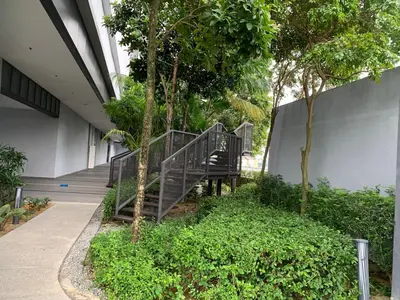 a staircase leading into a building with trees at Homestay at Trion Kuala Lumpur in Kuala Lumpur