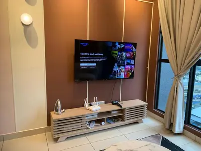 a living room with a flat screen tv on a wall at Homestay at Trion Kuala Lumpur in Kuala Lumpur