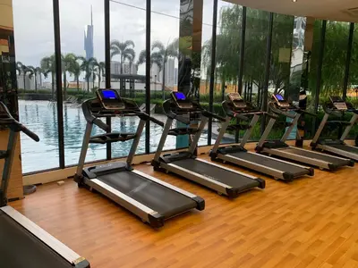 a row of treadmills in a gym with water at Homestay at Trion Kuala Lumpur in Kuala Lumpur