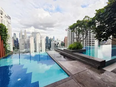 a large swimming pool on the roof of a building at KLCC View Pool & Gym 1 Bedroom Near LRT and Mall in Kuala Lumpur