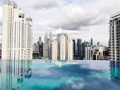 a swimming pool with a view of a city at KLCC View Pool & Gym 1 Bedroom Near LRT and Mall in Kuala Lumpur