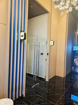 a hallway with a glass door in a building at KLCC View Pool & Gym 1 Bedroom Near LRT and Mall in Kuala Lumpur