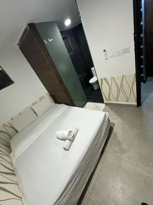 a white bed with a towel on it in a room at Day Cocoon In City Kuala lumpur in Kuala Lumpur