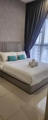 a large bed with blue pillows in a bedroom at Homestay at Trion KL in Kuala Lumpur