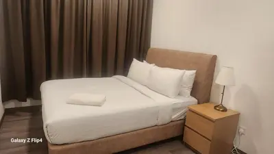 a bedroom with a bed with white sheets and pillows at Homestay at Trion KL in Kuala Lumpur