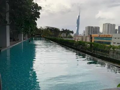 a large swimming pool with a city in the background at Homestay at Trion KL in Kuala Lumpur