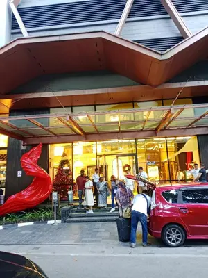 a red car parked in front of a store at SafeHouse At Scarletz Suite KLCC in Kuala Lumpur