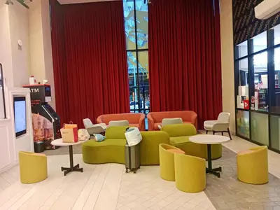 a waiting room with couches and tables in a store at SafeHouse At Scarletz Suite KLCC in Kuala Lumpur