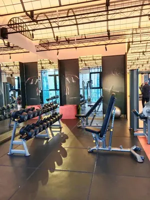 a gym with rows of treadmills and machines at SafeHouse At Scarletz Suite KLCC in Kuala Lumpur