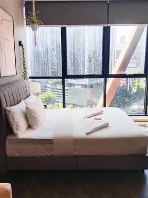 a large bed in a room with a large window at SafeHouse At Scarletz Suite KLCC in Kuala Lumpur