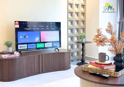 a television sitting on a table in a living room at Agile Residence l 5 mins to TRX l Pavillion l Bukit Bintang l KLCC l Games Room l 4-7pax l City Centre by Jay Stay Management in Kuala Lumpur