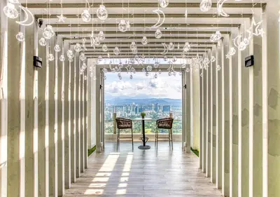 a hallway with two chairs in a building with a view at Agile Residence l 5 mins to TRX l Pavillion l Bukit Bintang l KLCC l Games Room l 4-7pax l City Centre by Jay Stay Management in Kuala Lumpur