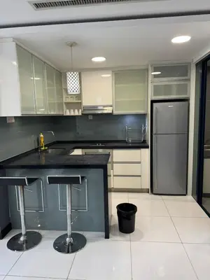 a kitchen with a black counter and a refrigerator at Casa Residency RH Homes in Kuala Lumpur