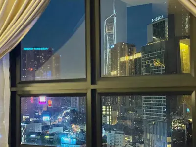 a view of a city skyline from a window at 2min walk to TRX,KLCC view Gaming 2pax swimming pool in Kuala Lumpur