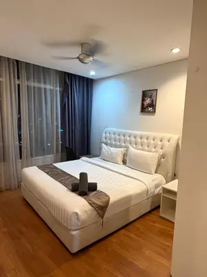 a bedroom with a large white bed in a room at Kuala-lumpur City View Vortex Apartment in Kuala Lumpur