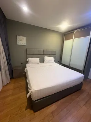 a bedroom with a large bed with white sheets at Kuala-lumpur City View Vortex Apartment in Kuala Lumpur