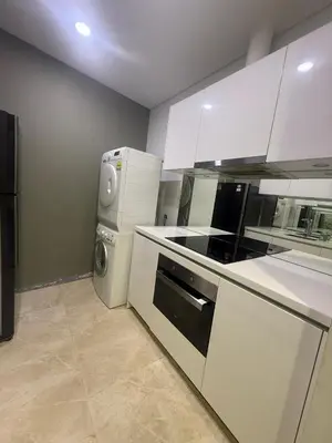 a kitchen with a refrigerator and a washer and dryer at Kuala-lumpur City View Vortex Apartment in Kuala Lumpur