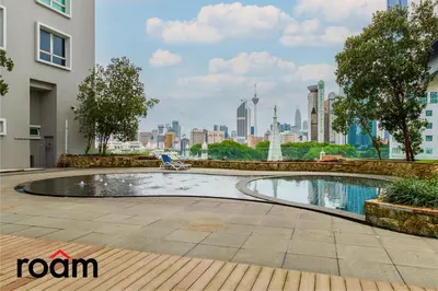a swimming pool with a city skyline in the background at Dua Sentral Transit Suites KL Sentral in Kuala Lumpur