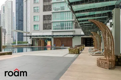 a swimming pool in a city with tall buildings at Dua Sentral Transit Suites KL Sentral in Kuala Lumpur