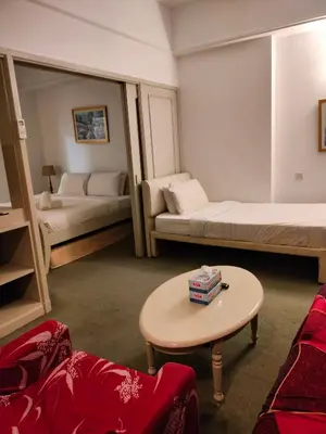 a living room with two beds and a table at KL Brave Suite at Times Square in Kuala Lumpur