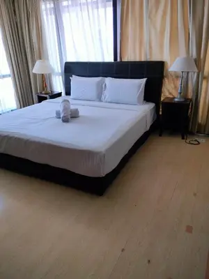 a bedroom with a large bed with white sheets at KL Brave Suite at Times Square in Kuala Lumpur