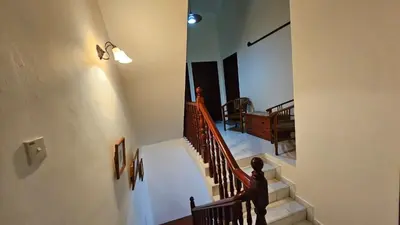 a staircase in a house with a stair case at Cozy Private Room in Taman Desa with Shared Bathroom in Kuala Lumpur