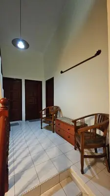 a living room with two wooden chairs and a table at Cozy 2 Private Rooms in Taman Desa with Shared Bathroom in Kuala Lumpur