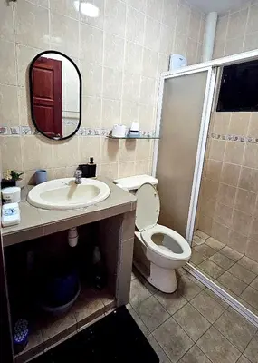 a bathroom with a toilet and a sink and a mirror at Cozy 2 Private Rooms in Taman Desa with Shared Bathroom in Kuala Lumpur
