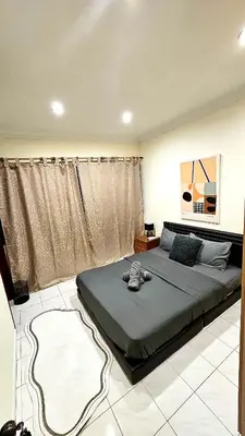 a bedroom with a large bed in a room at Cozy 2 Private Rooms in Taman Desa with Shared Bathroom in Kuala Lumpur